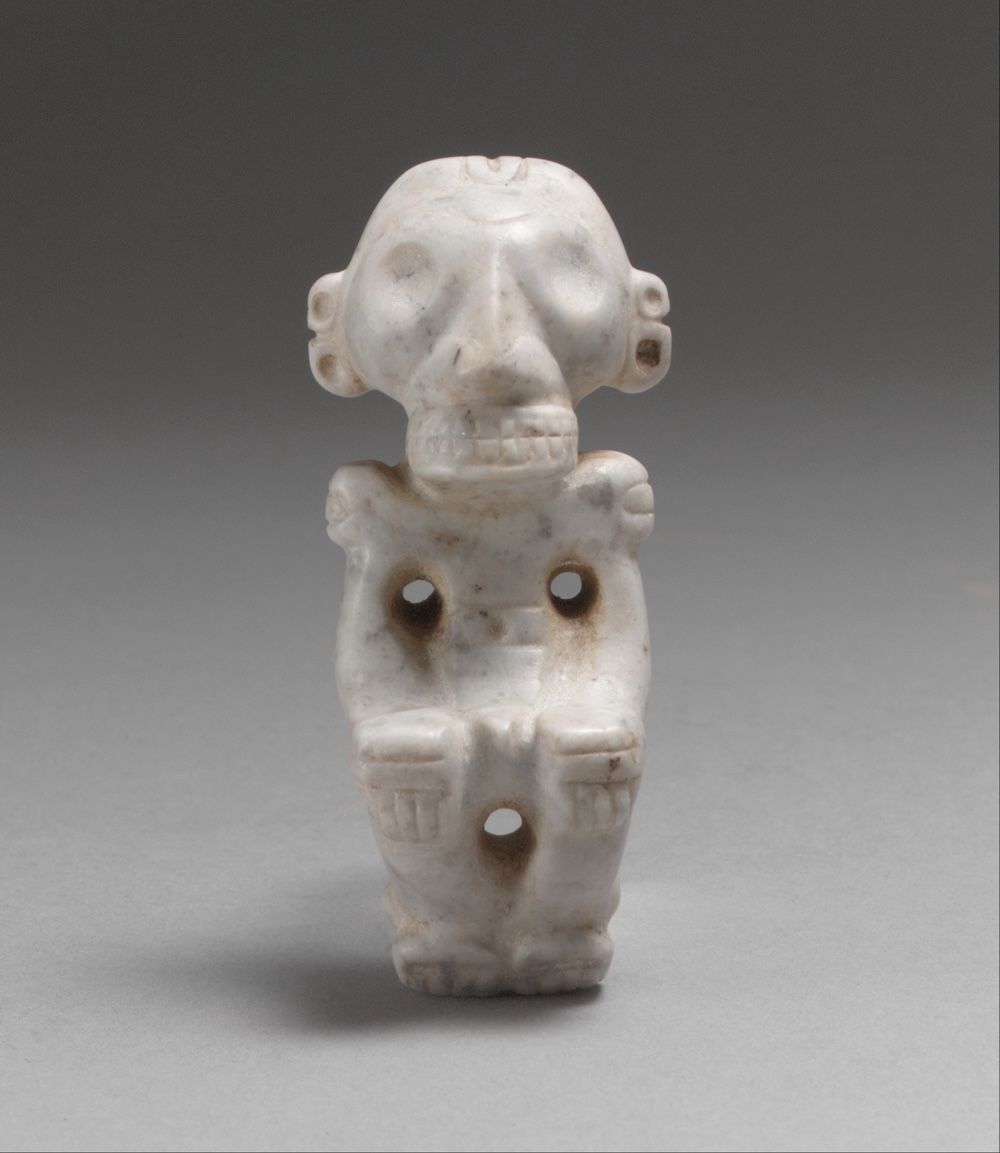 A small carved pendant in the form of a figure, drilled for suspension at the top.
