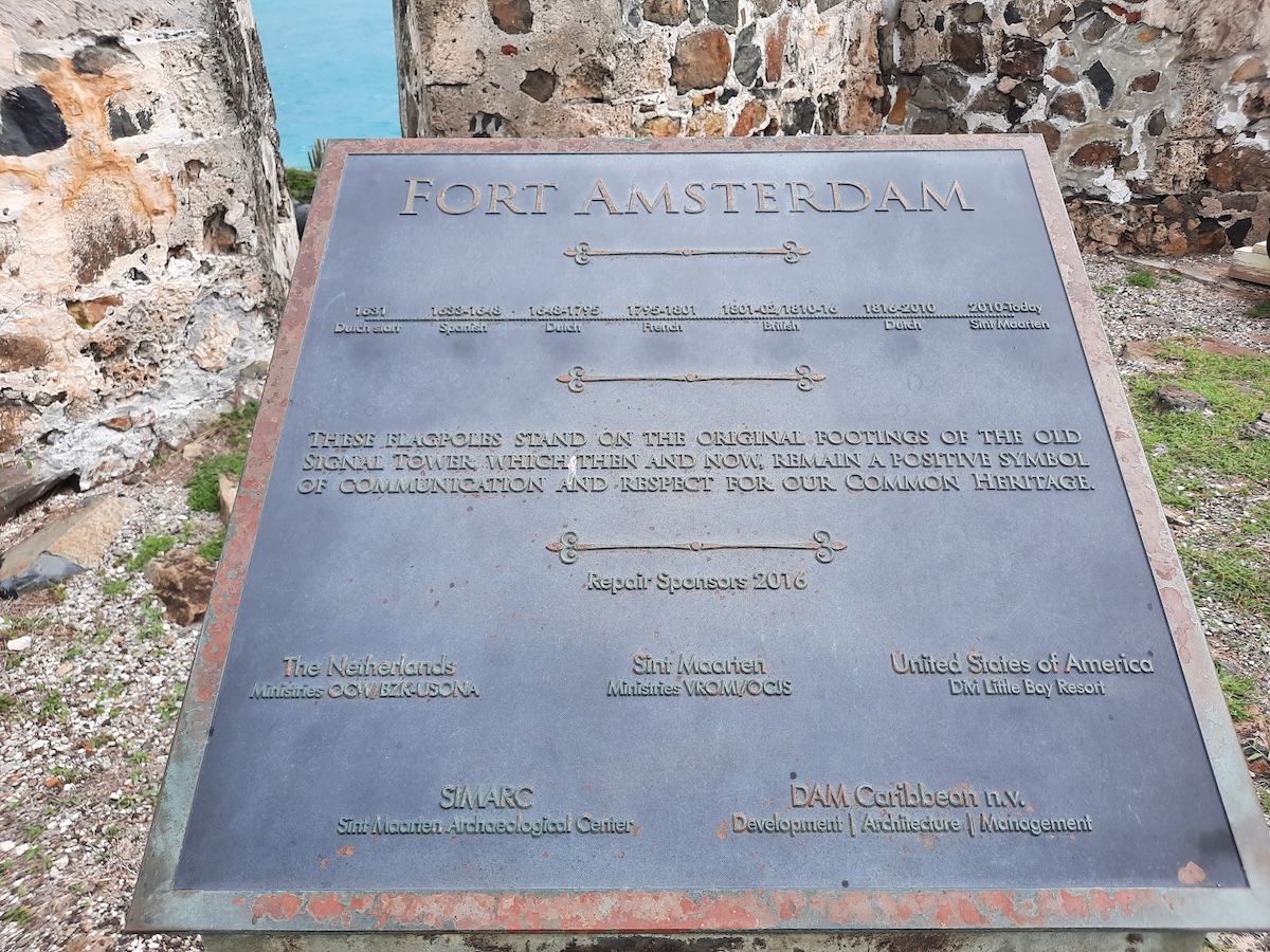 A bronze plaque mounted on stone at Fort Amsterdam, listing the periods of Dutch, Spanish, French and British control of the fort from 1631 onward.
