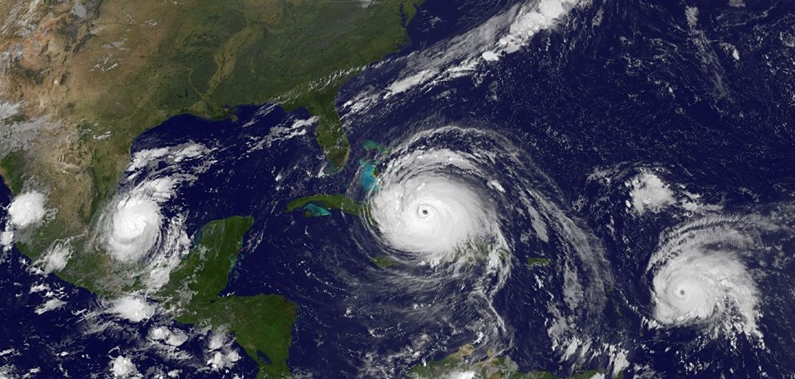 A wide satellite image showing three hurricanes at once across the Gulf and Atlantic: Katia to the west, Irma at the centre near Cuba and Florida, and José to the east.