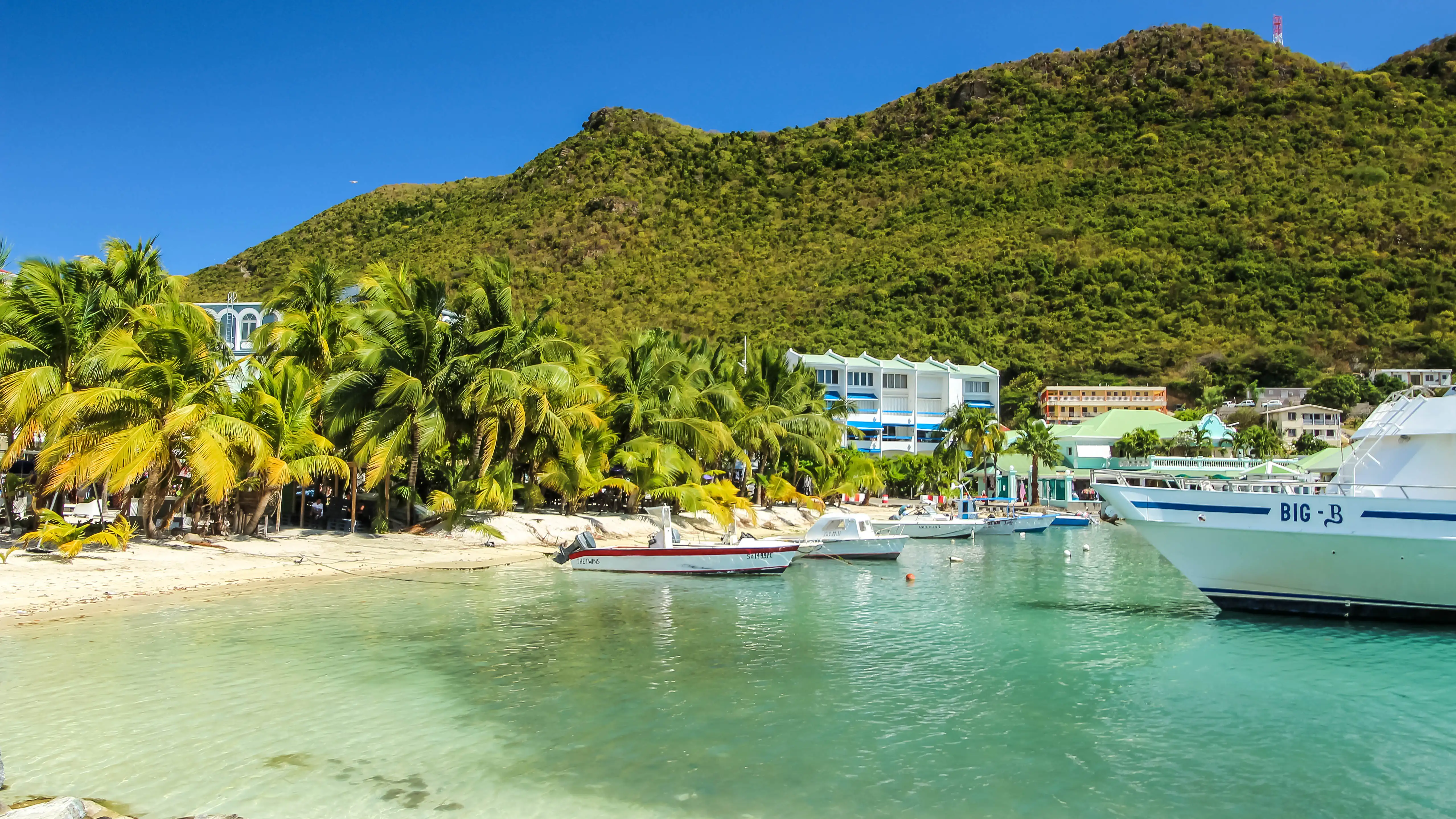The long sweep of Great Bay Beach running along the Philipsburg waterfront under a bright sky