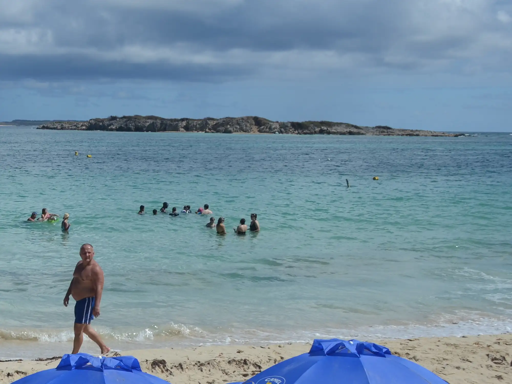 Green Cay islet seen from the shore at Orient Bay across open water