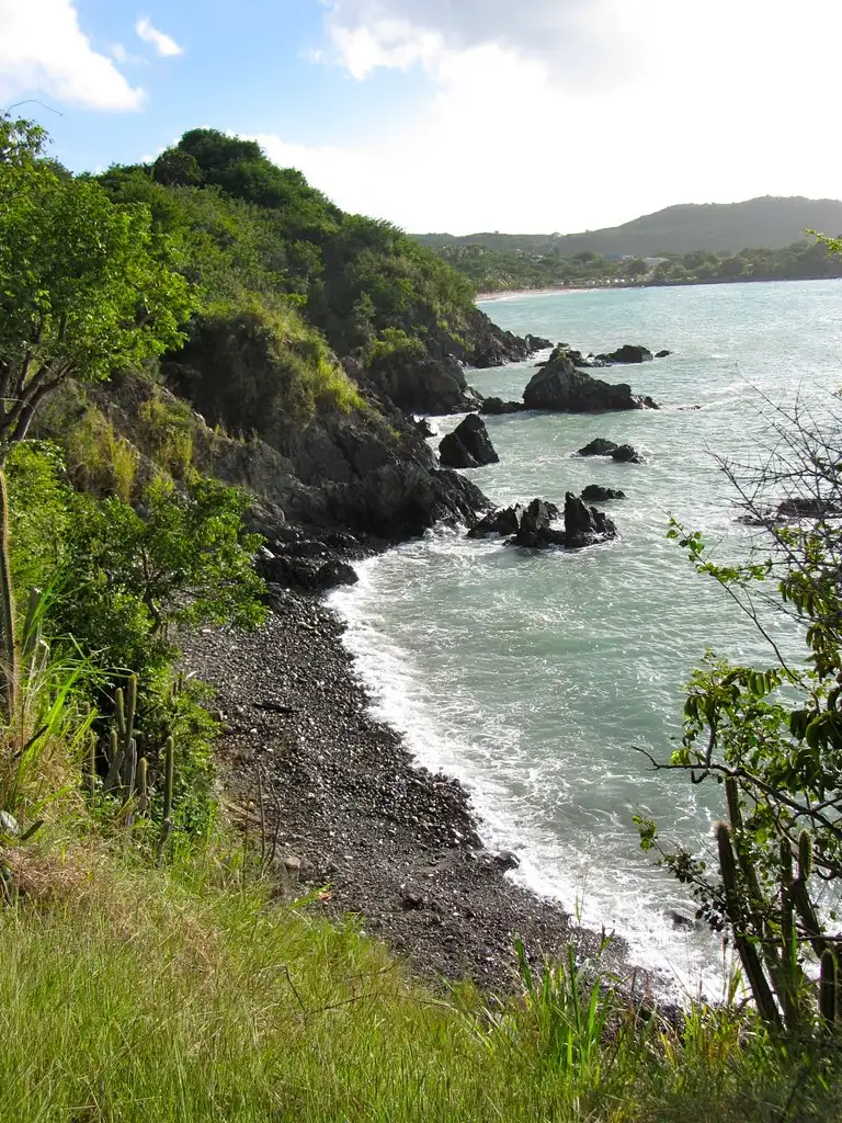 The footpath over the headland to Happy Bay, looking back down the rough track toward Friar's Bay below