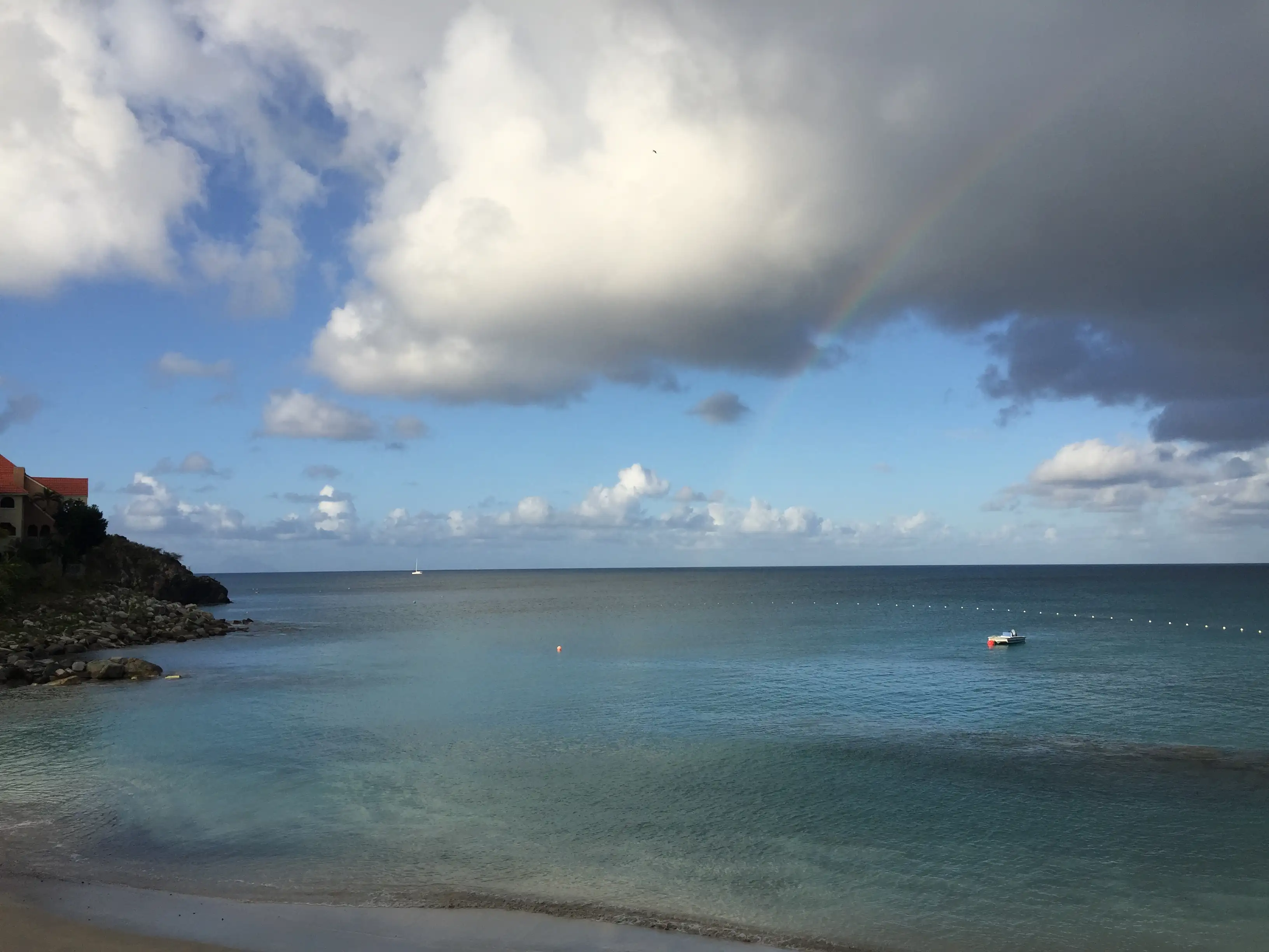 Little Bay seen from the Divi resort with cloud building over the water and the sheltered bay curving away