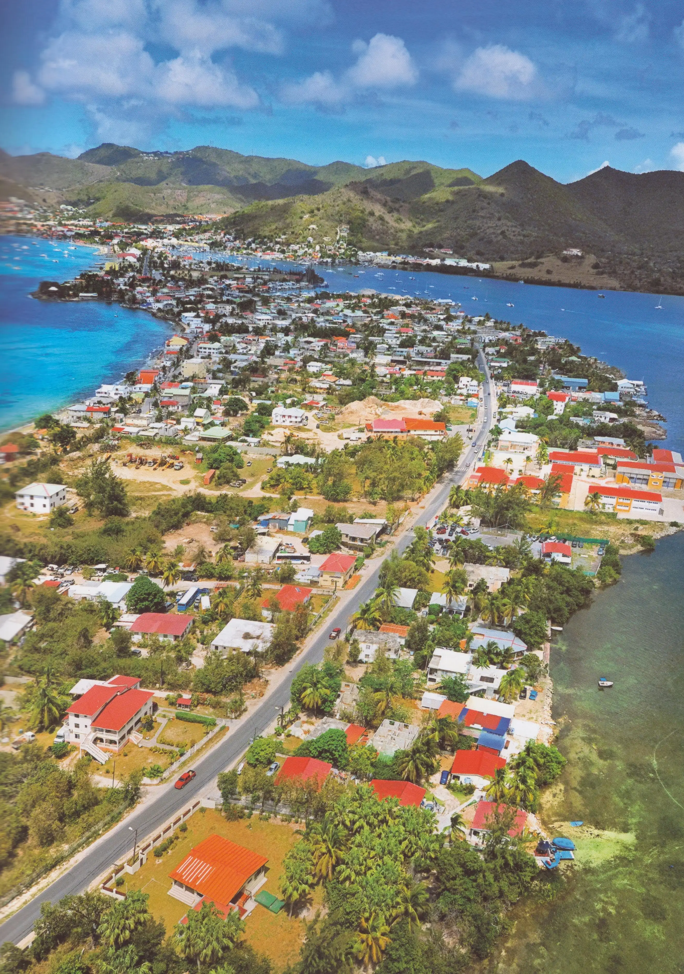 Aerial view of the narrow Sandy Ground and Baie Nettlé strip, with the open sea along one edge and Simpson Bay Lagoon along the other
