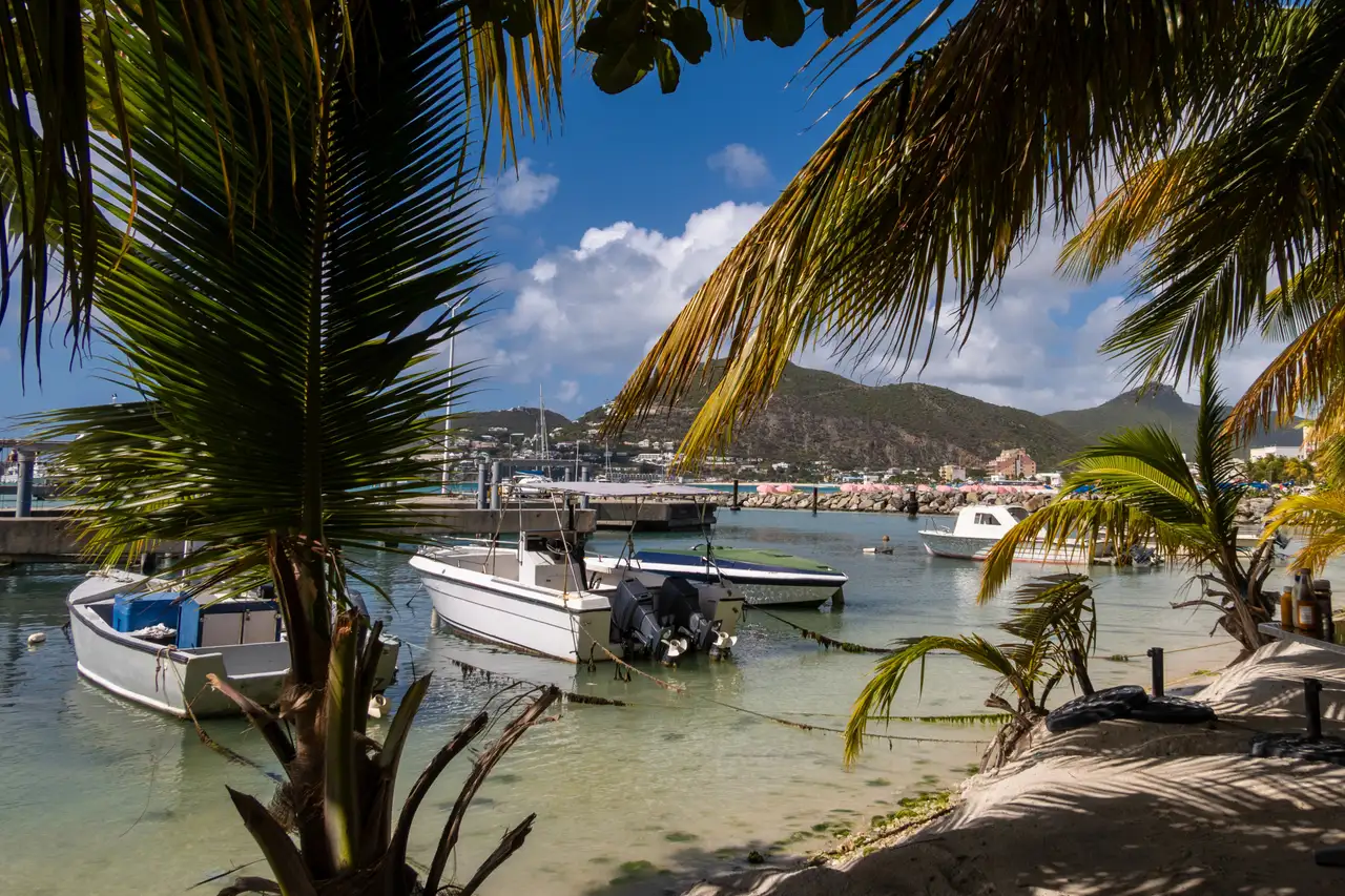 Small fishing boats moored in Great Bay, Philipsburg, with the town and surrounding hills in the background